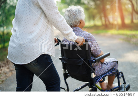 Asian senior or elderly old lady woman patient sitting on wheelchair at park 66514697