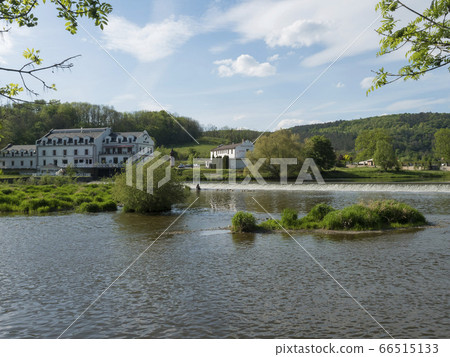 View on the river Berounka in village Zadni Treban with weir and building of Hotel Mlyn Karlstejn, sunny summer day, Czech Rupublic 66515133