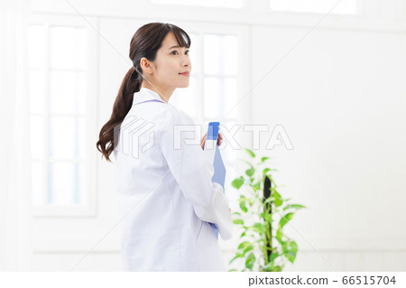 A woman wearing a white coat 66515704