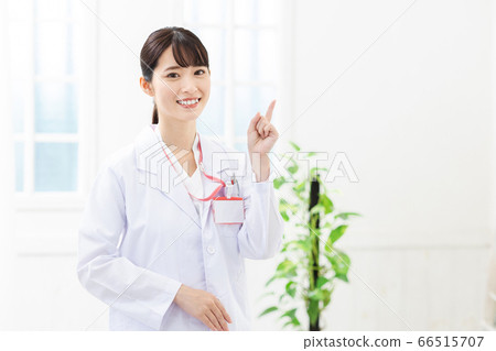 A woman wearing a white coat A woman wearing a white coat 66515707
