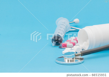 Tablet medical stethoscope and injection on a blue background Tablet medical stethoscope and injection on a blue background 66515931