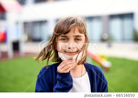 Portrait of happy child with face mask going back to school after covid-19 lockdown. 66516050