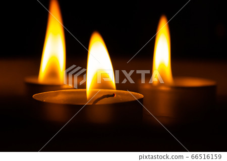 three candles in the dark, close up three candles in the dark, close up 66516159