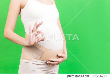Close up of pregnant woman wearing supporting 66516215
