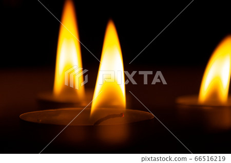 three candles in the dark, close up three candles in the dark, close up 66516219