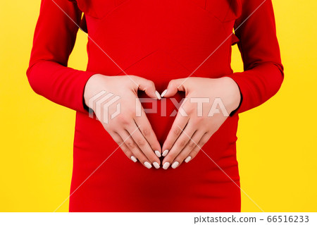 Cropped image of pregnant woman holding her hands 66516233