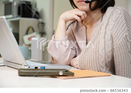 An image of a woman having a web conference at home, working from home An image of a woman having a web conference at home, working from home 66516343