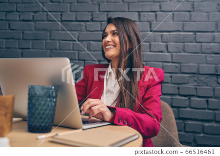 Amazing young woman working at her laptop 66516461