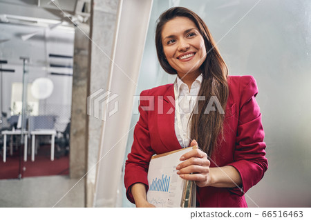 Young brunette female person working in business center 66516463