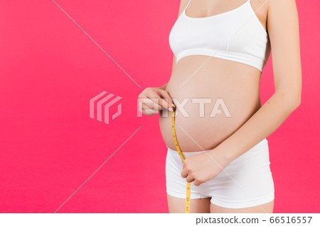 Cropped image of pregnant woman in white underwear 66516557