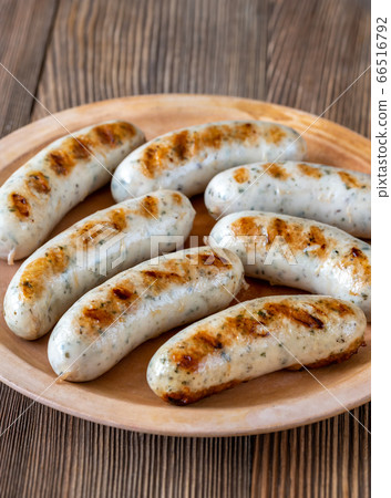 Grilled sausages on rustic plate 66516792