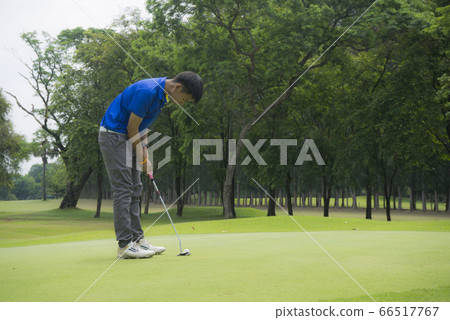 Blurred golfers are playing golf in the evening 66517767