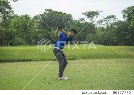 Blurred golfers are playing golf in the evening 66517770