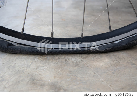 Flat Bicycle Tire on the Street Flat Bicycle Tire on the Street 66518553