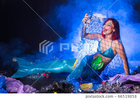 Ocean plastic pollution concept. Mermaid lives to polluted habitat. 66519858
