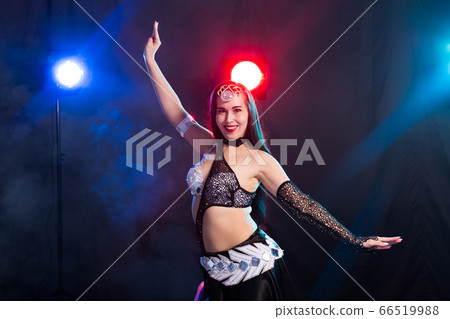 Spirituality dance. Beautiful sexy woman with luxury glossy eastern make-up dancing tribal fusion. Belly dance. 66519988
