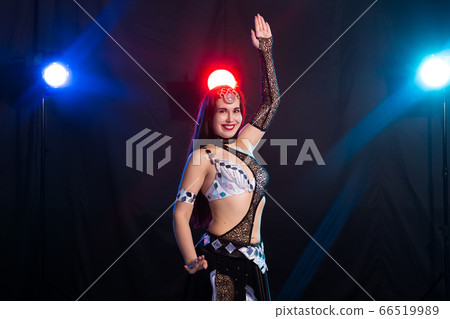 Spirituality dance. Beautiful sexy woman with luxury glossy eastern make-up dancing tribal fusion. Belly dance. Spirituality dance. Beautiful sexy woman with luxury glossy eastern make-up dancing tribal fusion. Belly dance. 66519989