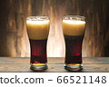 Two glass with dark beer and foam 66521148