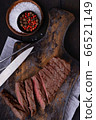 Sliced beef steak with knife and fork and spices 66521149
