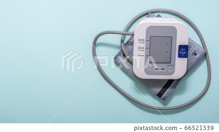 Device for measuring blood pressure on a blue medical background. Copy space. 66521339