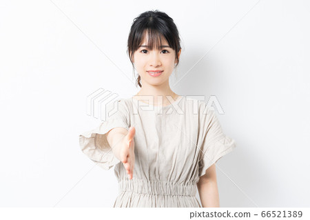 Young woman holding out hand with handshake Young woman holding out hand with handshake 66521389