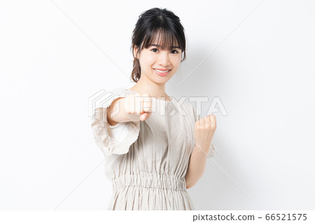 Young woman doing a punch pose 66521575