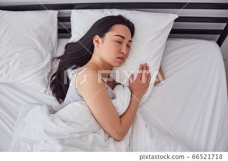 Charming Asian lady resting in her bad Charming Asian lady resting in her bad 66521718