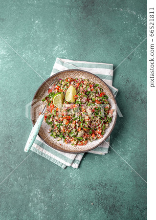 Traditional Lebanese salad tabouli tabule with quinoa, herbs, tomatoes, mint and lemon Traditional Lebanese salad tabouli tabule with quinoa, herbs, tomatoes, mint and lemon 66521811