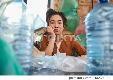 Disheveled female suffering because of clutter in her room Disheveled female suffering because of clutter in her room 66521982