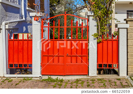 Entrance gate made of metal painted red. Entrance gate made of metal painted red. 66522059