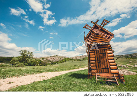 Wind mill on a hill. 66522096