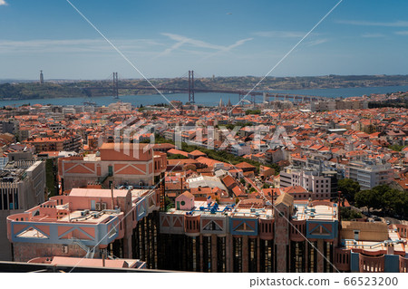 The capital of Portugal, Lisbon, top view of the orange roofs of houses, hotels and bridge 66523200