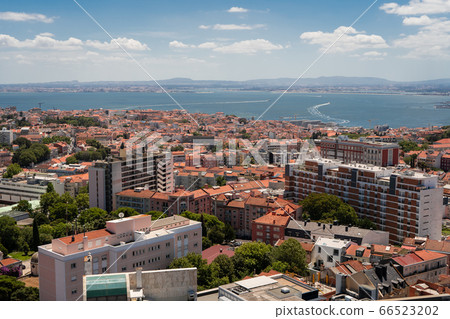 The capital of Portugal, Lisbon, top view of the orange roofs of houses, hotels, the sea coast 66523202