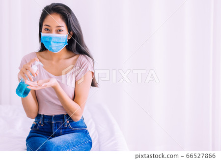 Young asian woman using sanitizer hand gel in pump bottle for hygiene coronavirus protection at home Young asian woman using sanitizer hand gel in pump bottle for hygiene coronavirus protection at home 66527866