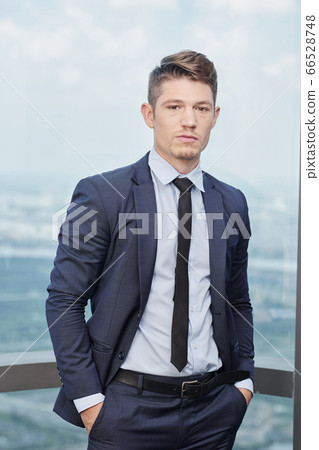 Handsome confident businessman Handsome confident businessman 66528748
