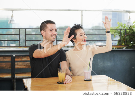 Cafe visitors waving with hands Cafe visitors waving with hands 66528858