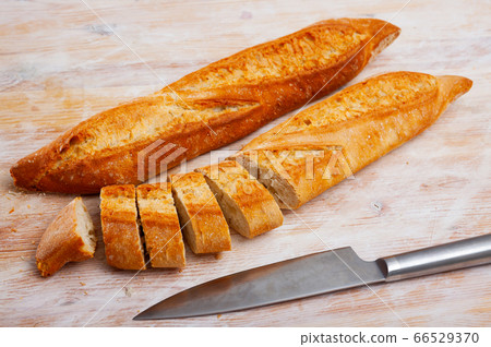 Whole and sliced french baguette Whole and sliced french baguette 66529370