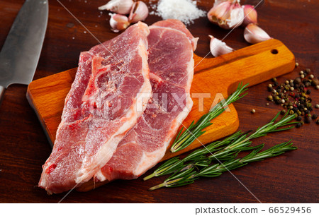 Preparation of raw pork shoulder on wooden board Preparation of raw pork shoulder on wooden board 66529456