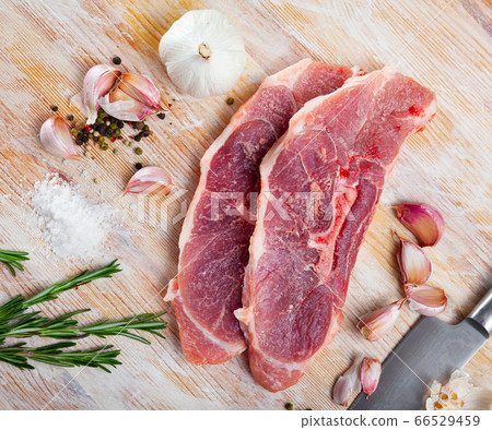 Preparation of raw pork shoulder on wooden board Preparation of raw pork shoulder on wooden board 66529459