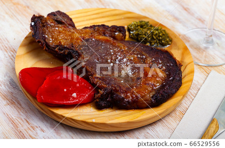 Fried veal entrecote with pesto and peppers 66529556
