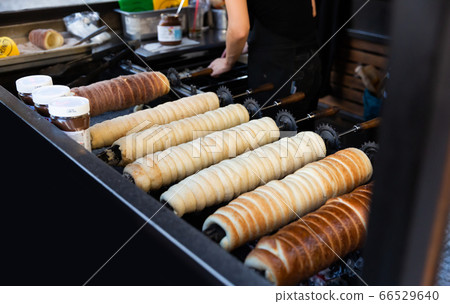 Cooking of Czech trdelnik on street market Cooking of Czech trdelnik on street market 66529640
