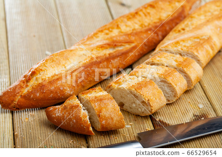 Fresh bread on a wooden cutting board Fresh bread on a wooden cutting board 66529654