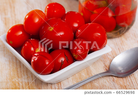 Marinated tomatoes on white plate 66529698