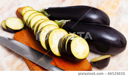 Slices of fresh eggplants on wooden surface, nobody Slices of fresh eggplants on wooden surface, nobody 66529830