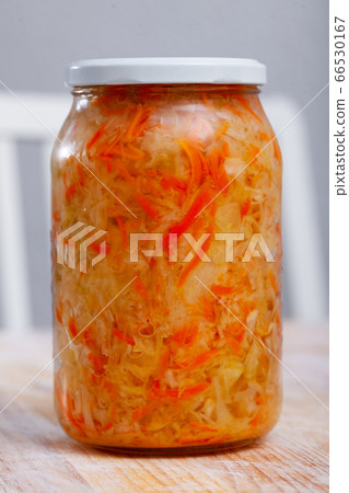 Glass jar with shredded fermented cabbage 66530167