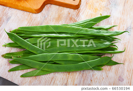 Green beans on wooden table 66530194