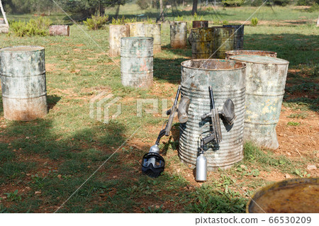 Protective mask and marker guns near barrels 66530209