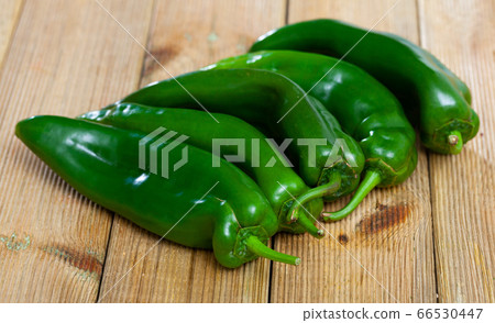 Green peppers on wooden background Green peppers on wooden background 66530447