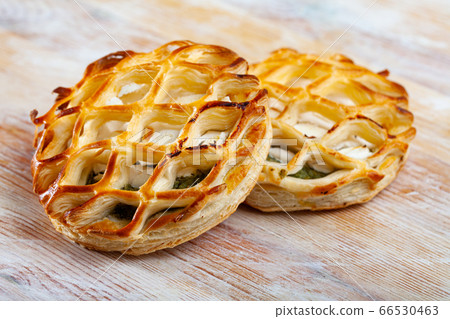 Puffs with goat cheese and spinach on wooden background 66530463