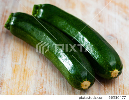Fresh zucchinis on wooden surface Fresh zucchinis on wooden surface 66530477